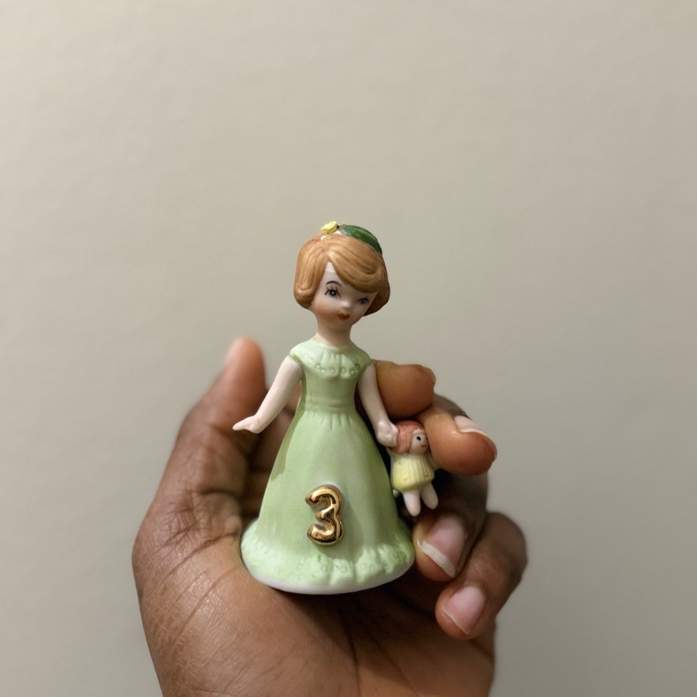 Charming Green Figurine with Doll